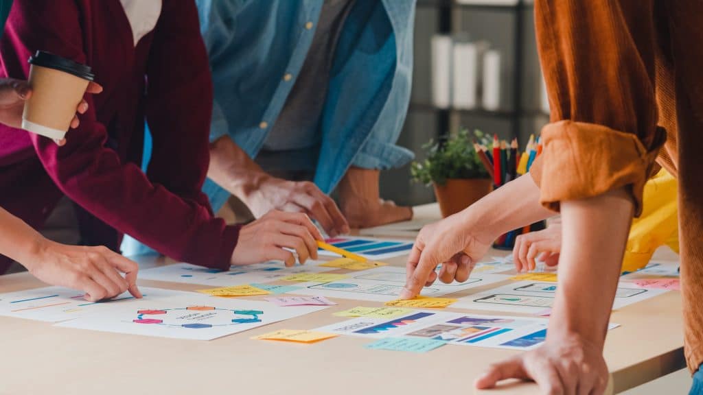 people looking at color graphs on table
